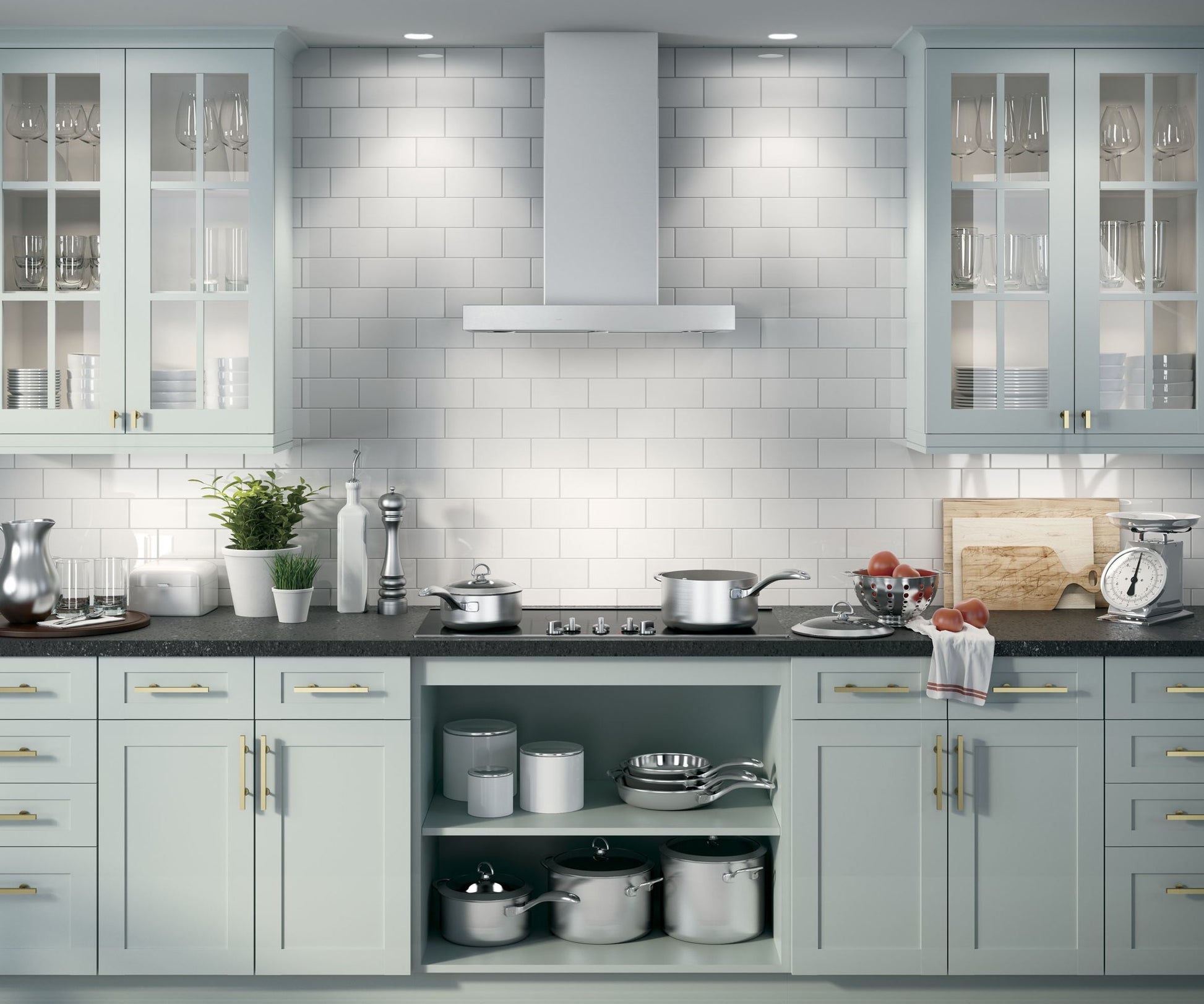 Modern kitchen with light cabinetry, stainless steel range hood, black countertop, and organized cookware in kitchenware collection