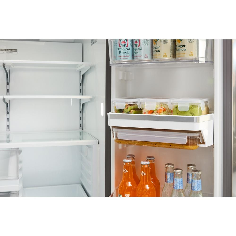 Open view of large capacity refrigerator interior with clear shelves and organized beverages from French Door Refrigerators collection