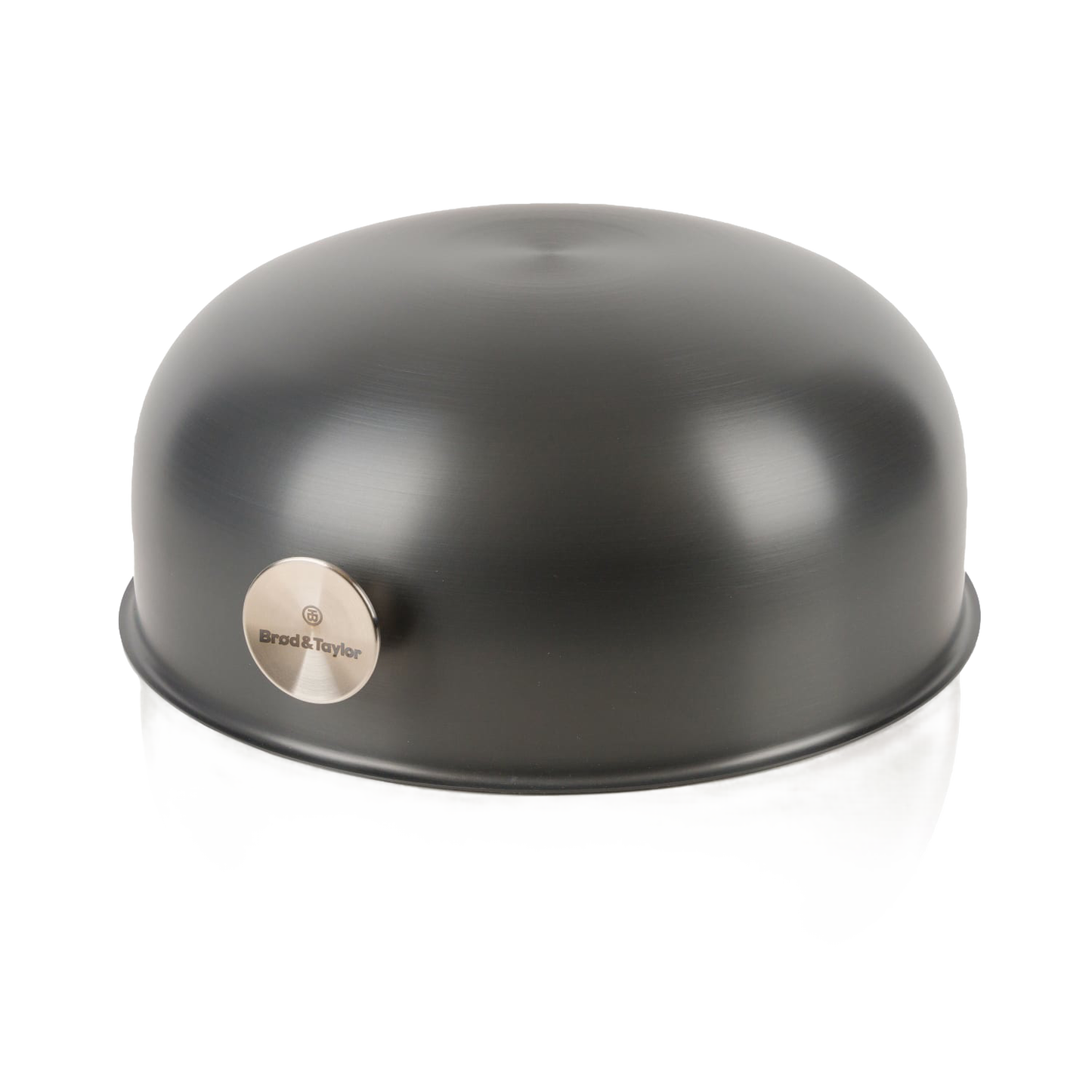 Matte black dome-shaped baking shell with stainless steel logo plate, kitchenware accessory for baking bread.