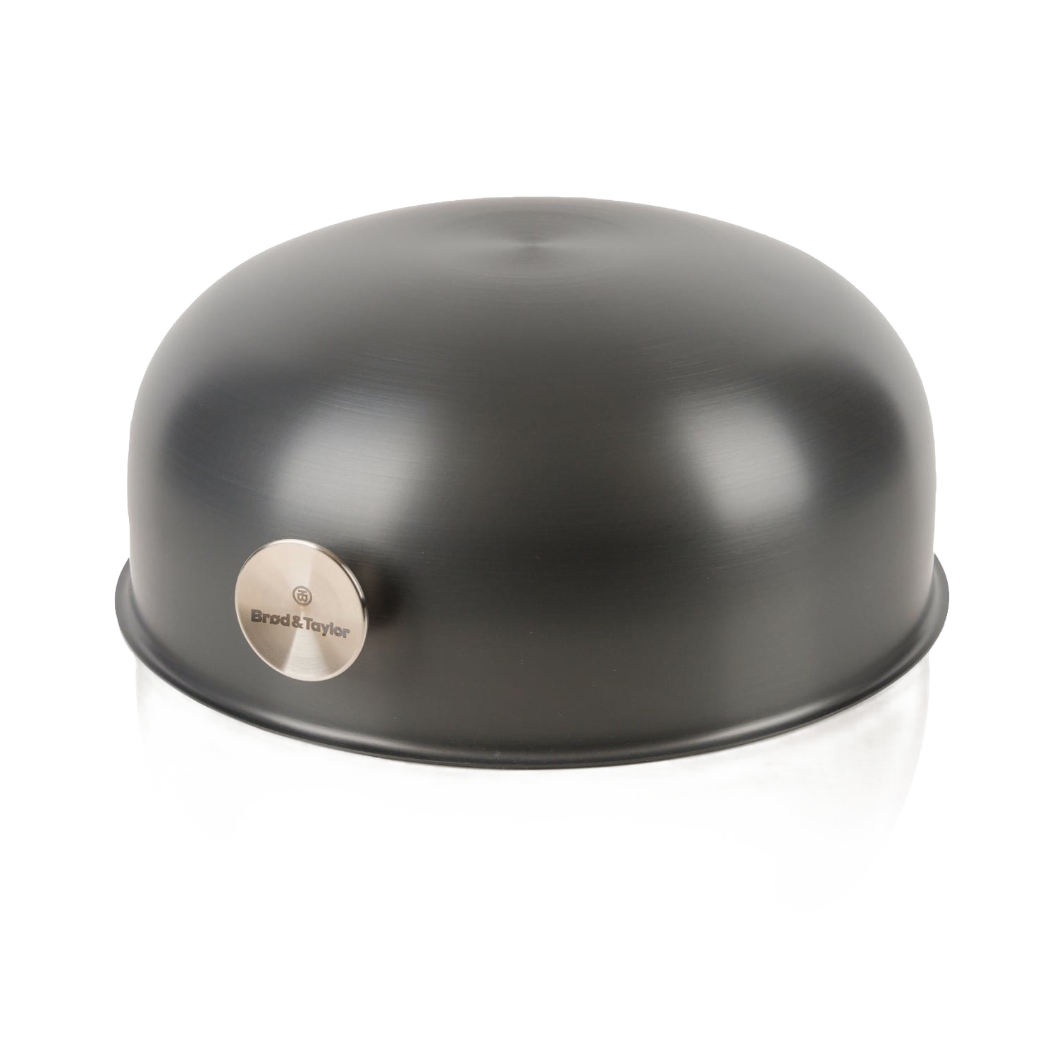 Matte black dome-shaped baking shell with stainless steel logo plate, kitchenware accessory for baking bread.