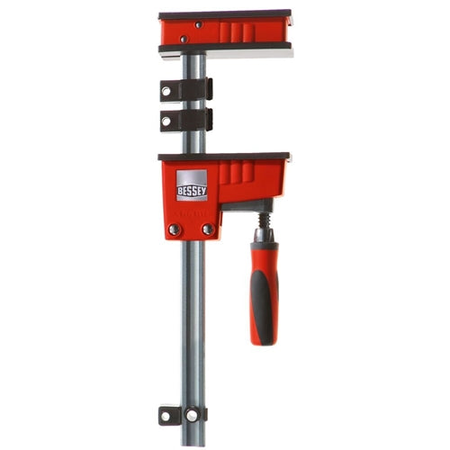 Red and black K body clamp with steel bar and ergonomic handle designed for woodworking and tool use