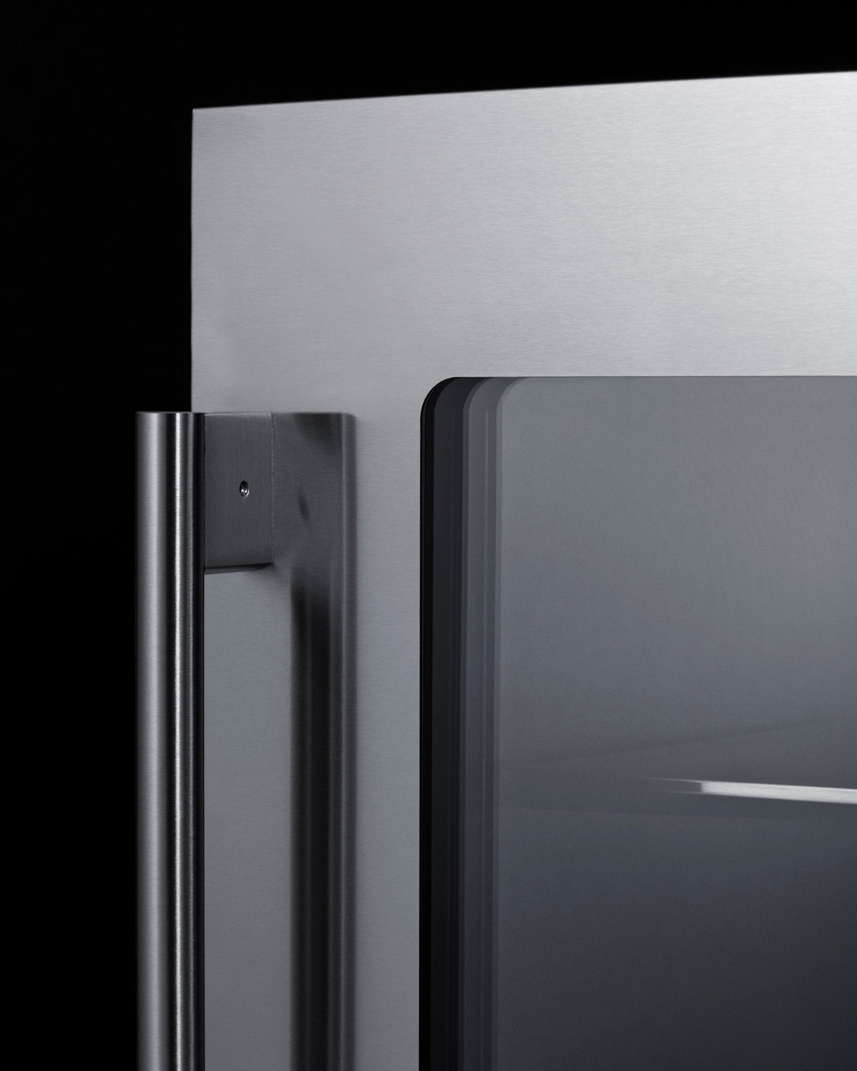 Close-up of stainless steel handle and glass door on a built-in beverage center from the Refrigerators collection