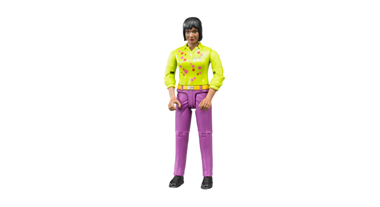 Toy figure of a medium skin tone woman wearing bright yellow shirt and pink jeans with black shoes, standing upright