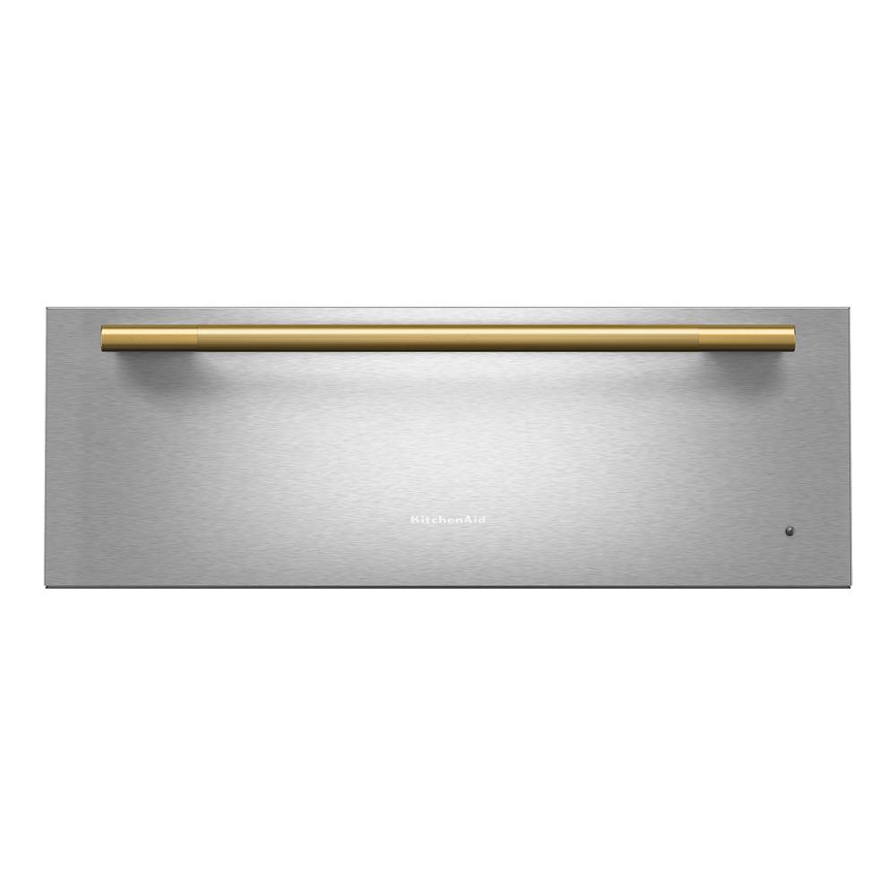 Brushed stainless steel warming drawer with gold horizontal handle in KitchenAid Appliances and Wall Ovens collections