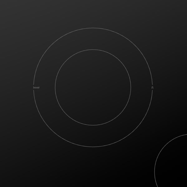 Close-up of black-glass induction cooktop heating zone with dual-size elements and subtle controls for kitchen appliances