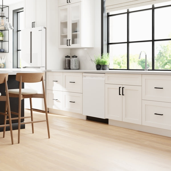 Built-in white dishwasher integrated into bright kitchen cabinetry with black hardware and large window from Kitchen & Kitchenware collection