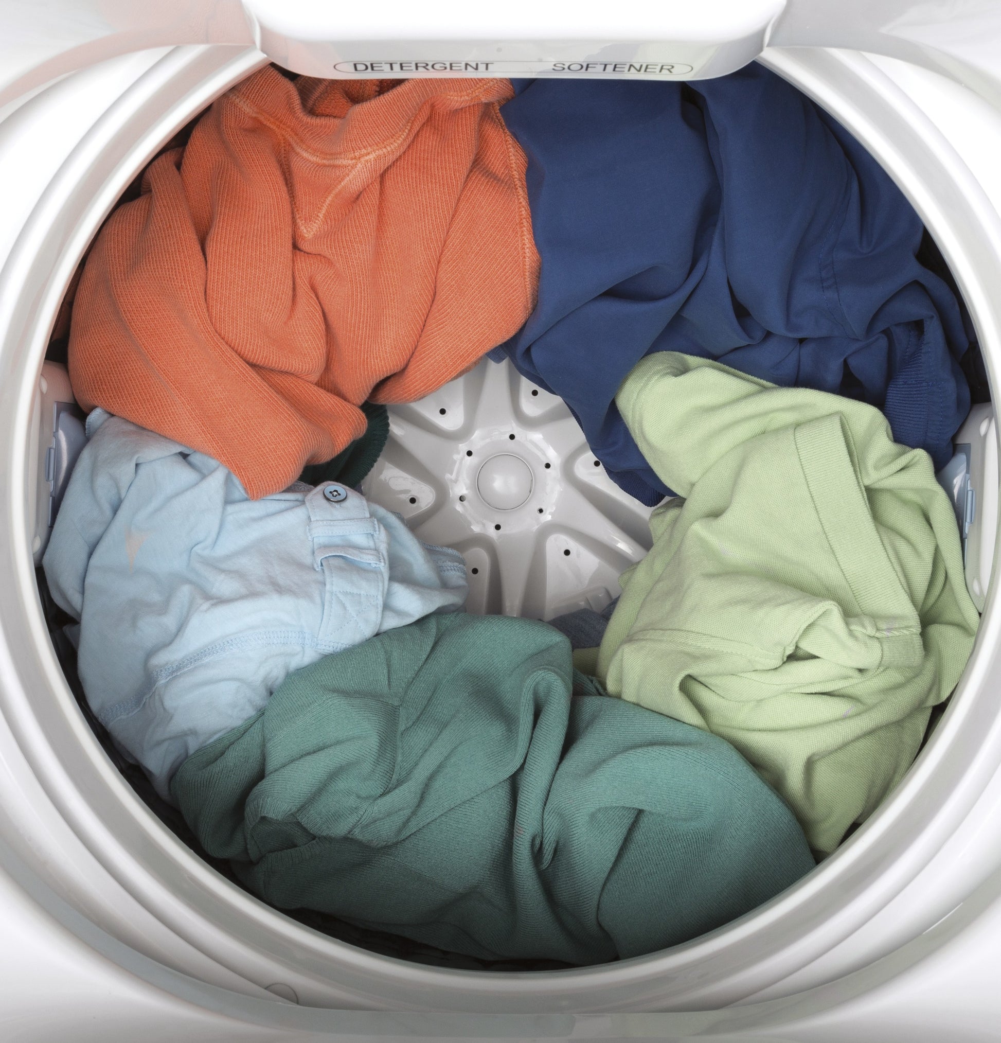 Top view inside of GE space-saving top load washer filled with colorful clothing in washers collection