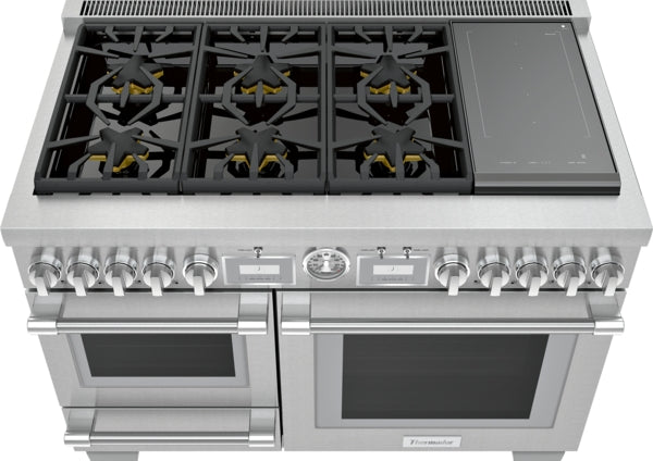 Stainless steel dual fuel range with six burners, induction cooktop, dual ovens, and front control knobs in Thermador collection