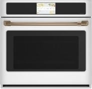 White built-in convection wall oven with touchscreen and brass handle in kitchen appliances and wall ovens collection