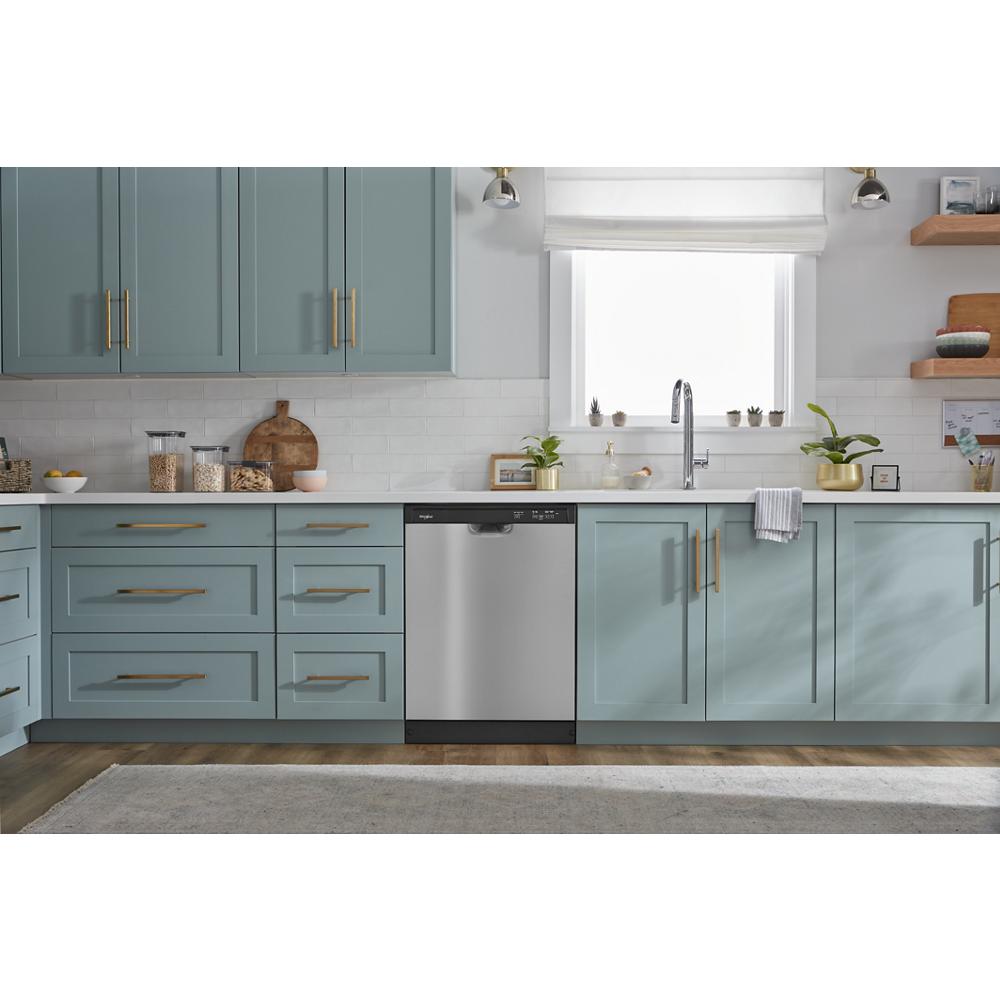 Stainless steel quiet dishwasher installed in pastel blue cabinetry with gold handles in a modern kitchen setting