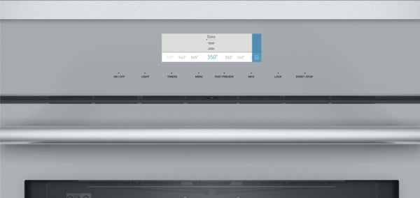 Close-up of stainless steel wall oven control panel with digital temperature display and touch buttons for kitchen appliances collection