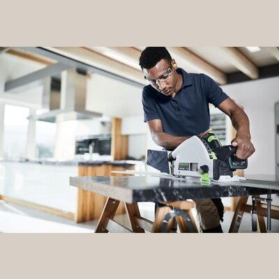 Person using Festool cordless track saw with kickback stop cutting wood indoors for power tools and home improvement