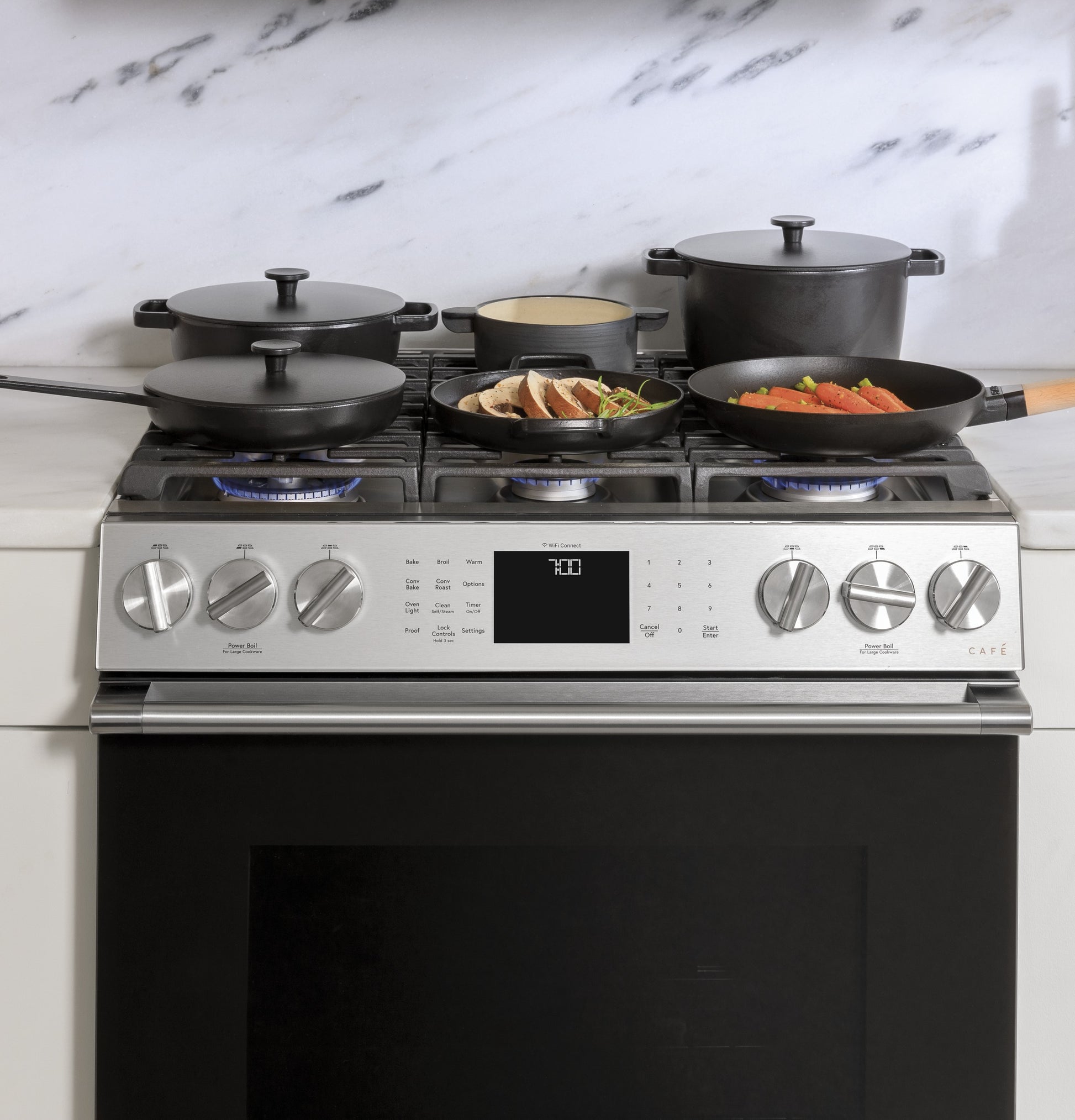 Front-control gas range with platinum glass finish cooking multiple pans and pots, part of kitchenware and appliance collections