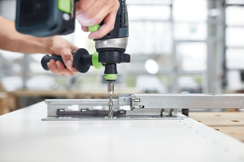 Electric drill with a 5mm Centrotec bit installing cabinet hardware in a home improvement setting