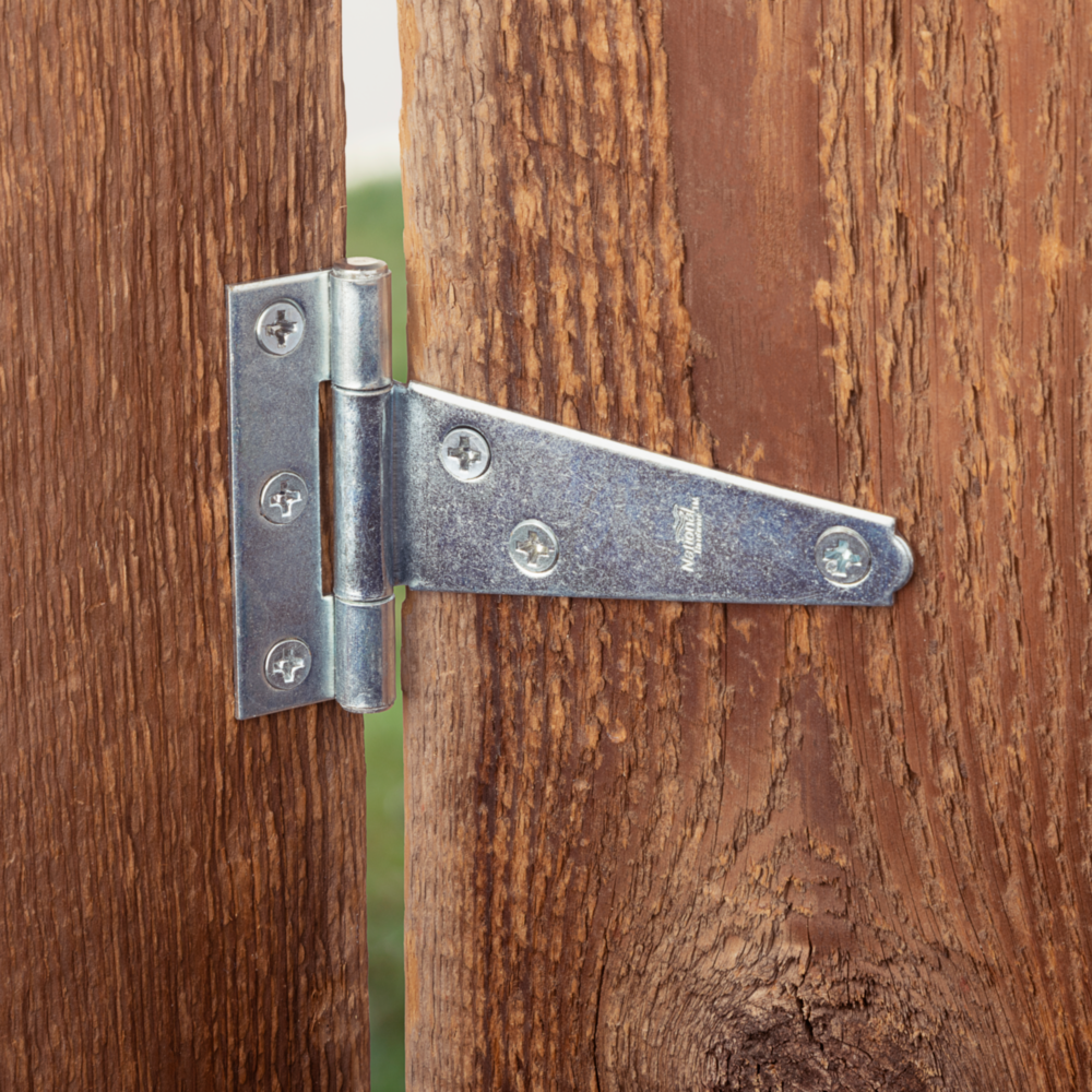 3-inch zinc plated light duty T-hinge installed on wood gate for door hardware and home improvement under $50