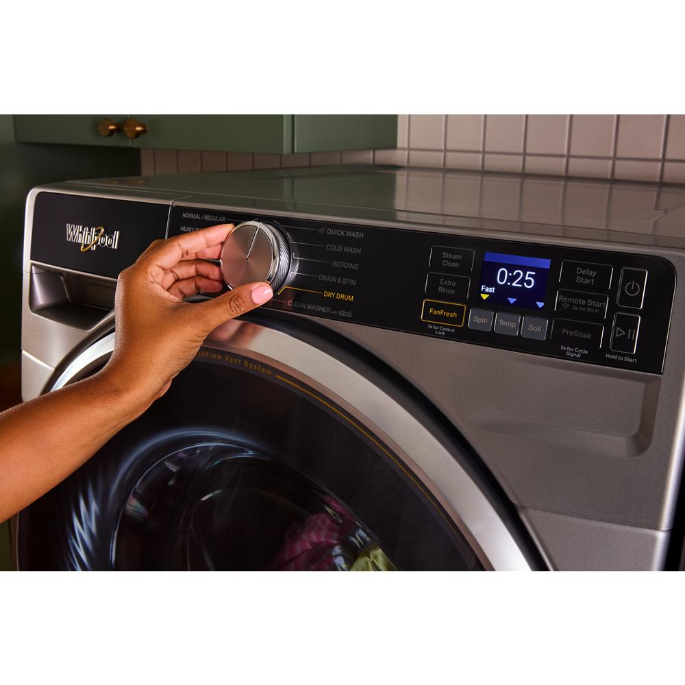 Hand adjusting cycle selection knob on silver smart front load washer control panel with digital display on appliances collection