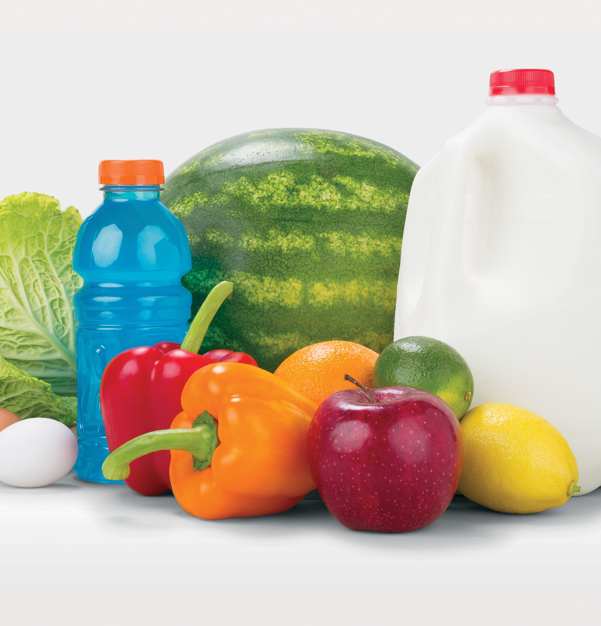 Assortment of fresh produce including watermelon, bell peppers, apple, lemon, and drinks for kitchen and home improvement use