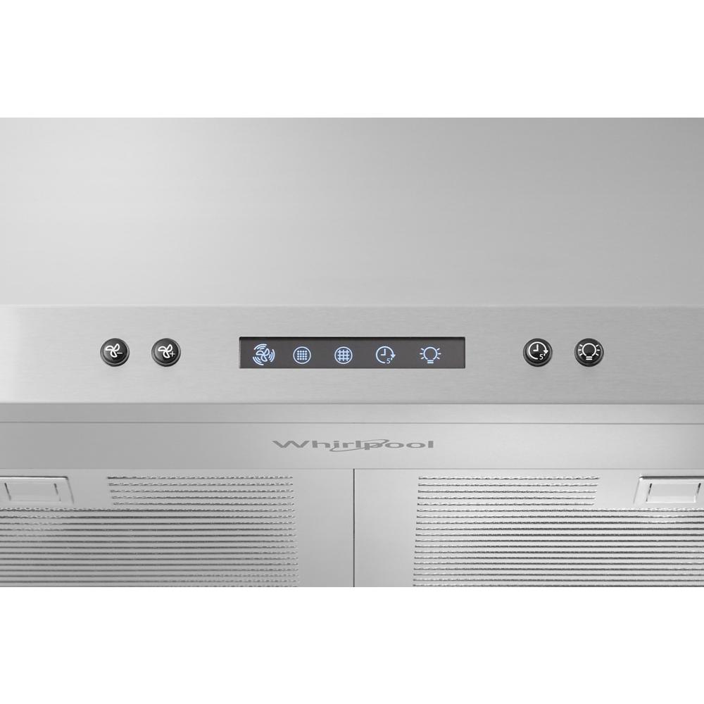 Close-up of stainless steel range hood control panel with digital display and touch buttons in kitchen appliance setting