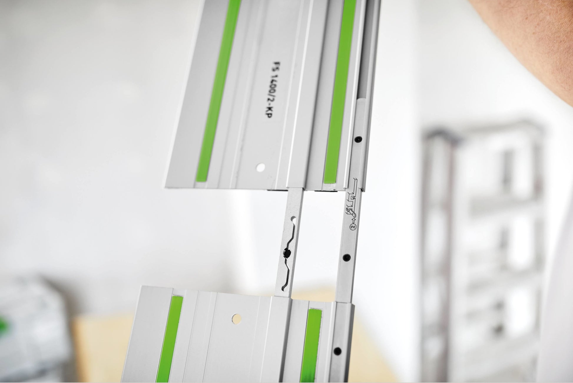 Two aluminum guide rail connectors aligning guide rails for woodworking and power tool accessories installation
