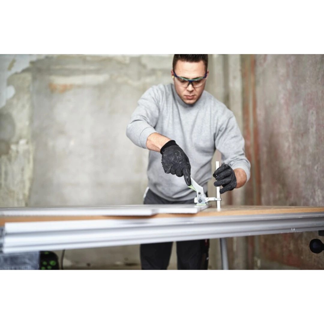 Man with safety glasses using Festool 491594 Quick Clamp FS on guide rail for woodworking in tool accessories collection