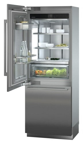 Open stainless steel built-in refrigerator/freezer with glass shelves and vegetable drawer in kitchen appliances collection