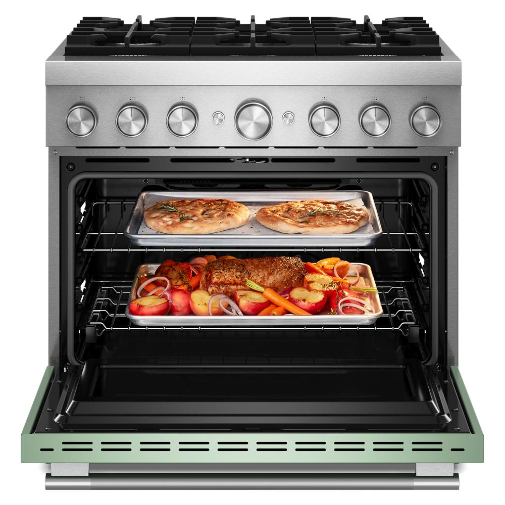 36-inch commercial-style dual fuel range with stainless steel finish and open oven showing two trays of food inside