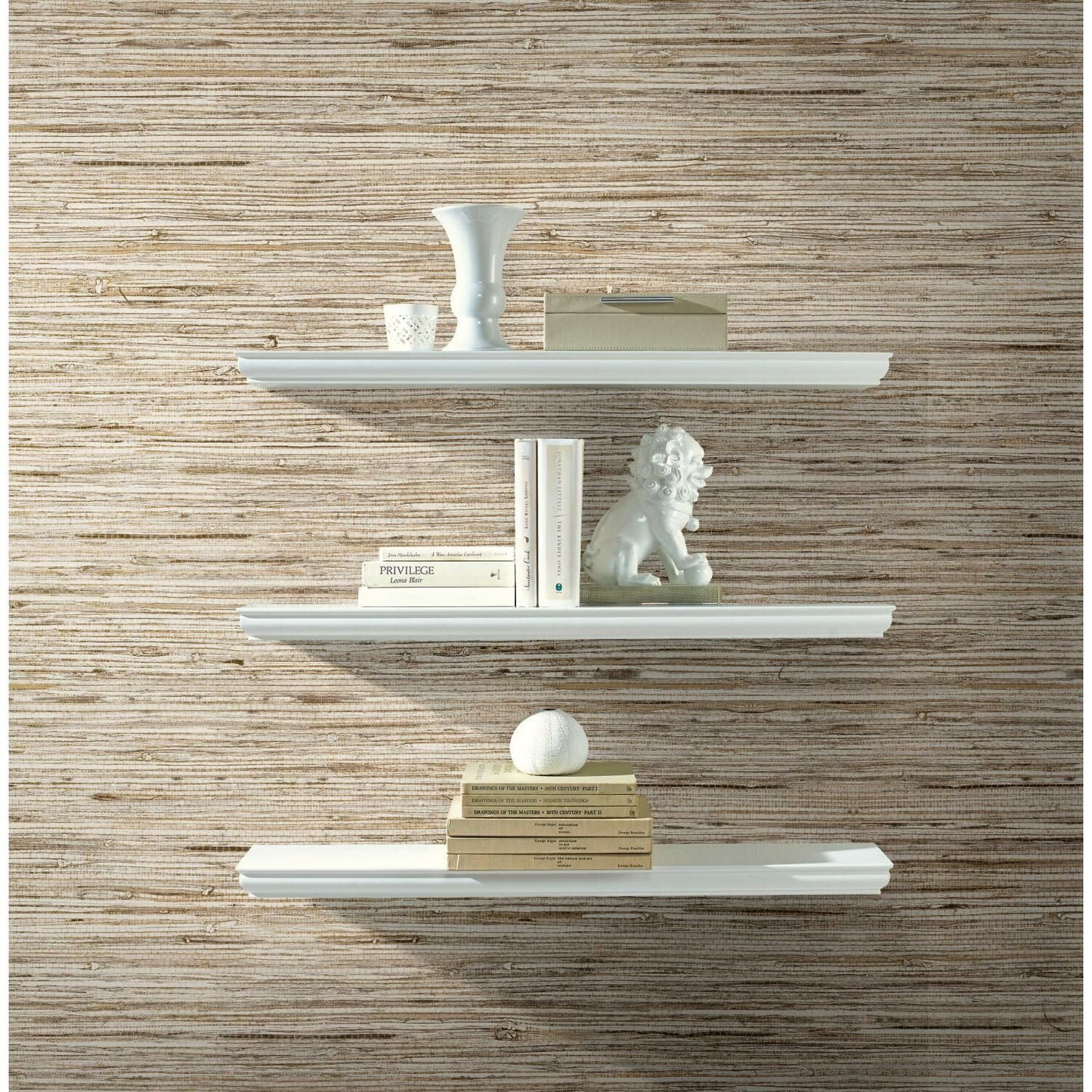 Light beige faux weave grasscloth wallpaper behind white floating shelves with decorative objects for home decor