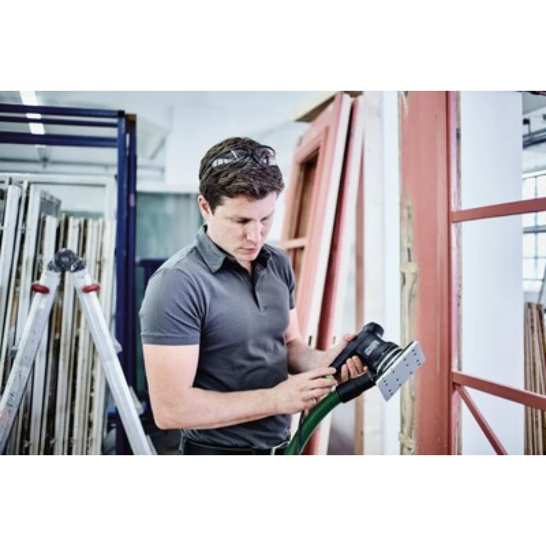 Man wearing safety glasses using power sanding tool on wooden frame in woodworking tool accessories collection