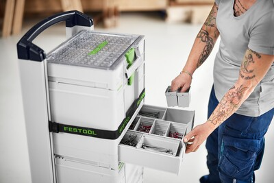 White and green Festool modular storage system with removable compartments organizing hardware for jobsite and workshop use
