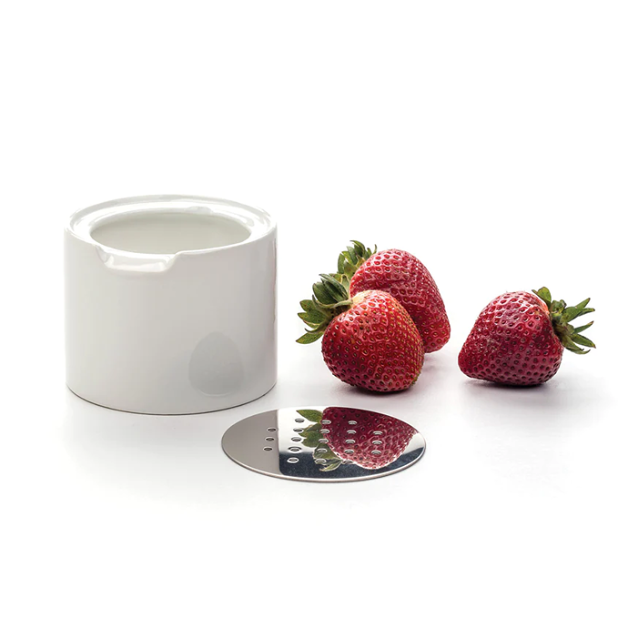 White ceramic and stainless steel trap with perforated lid next to fresh strawberries in under $50 office supplies collection