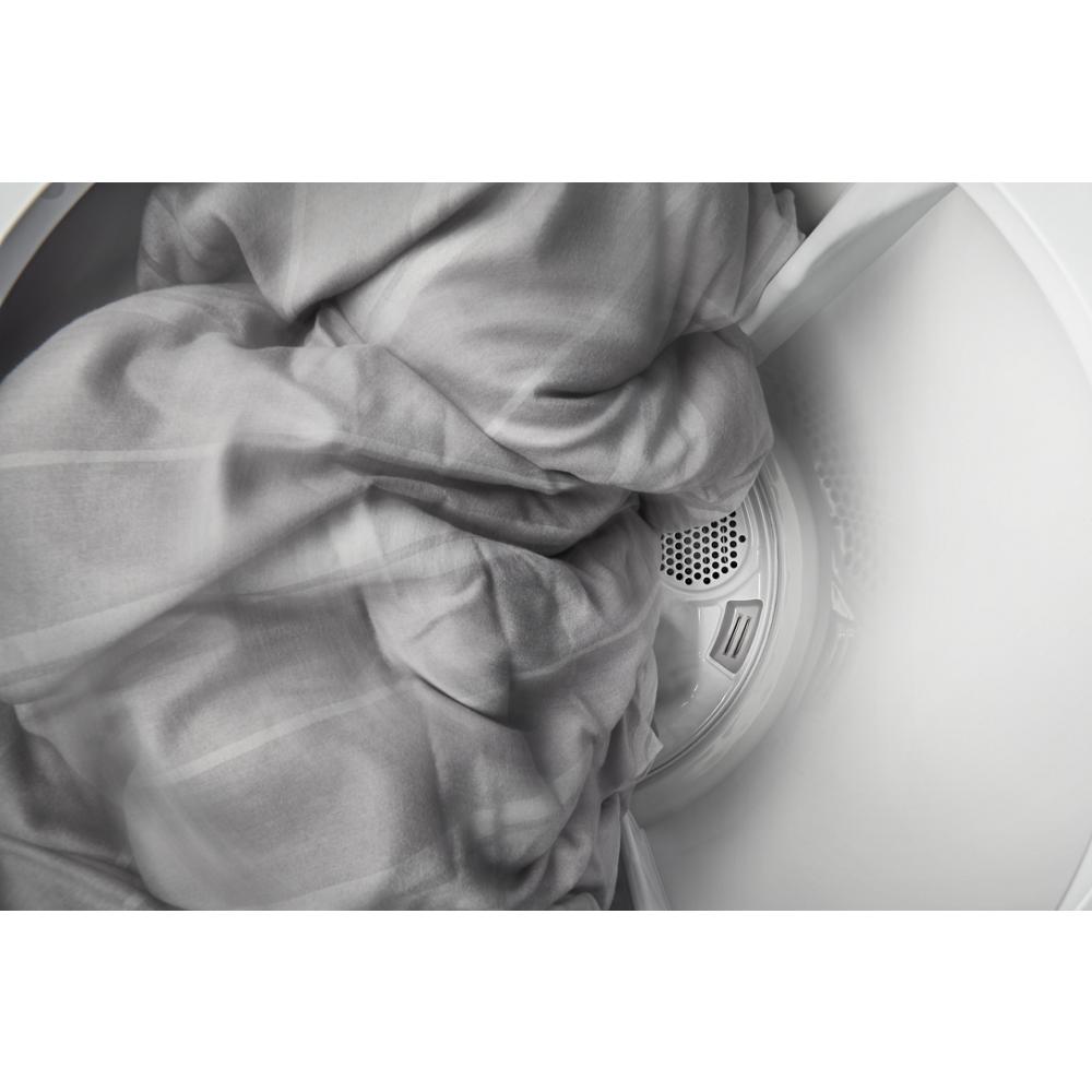 Gray fabric tumbling inside the drum of a top load electric dryer from the dryers and home appliances collection