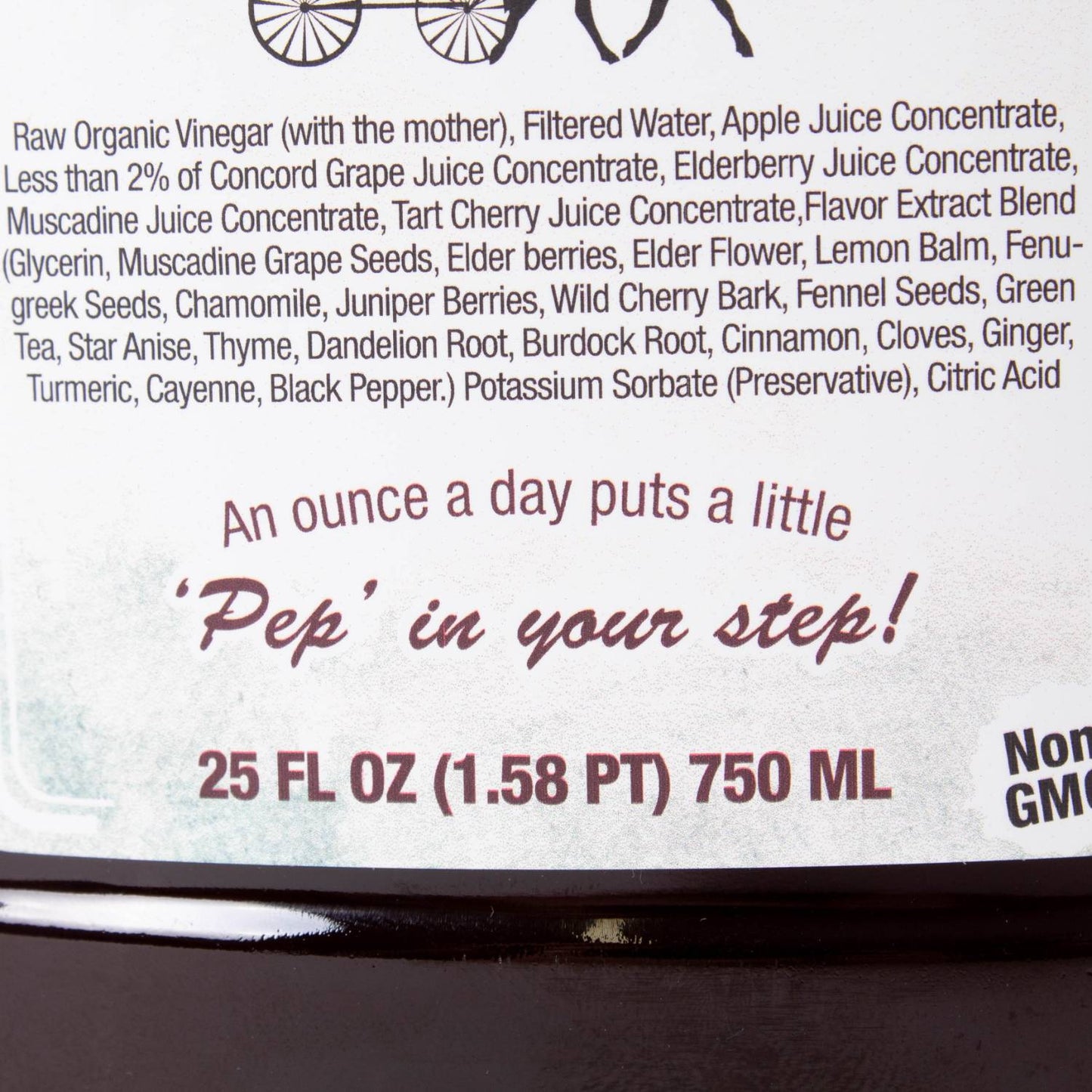Close-up of herbal tonic label listing organic juice concentrates, herbs, and daily use recommendation on amber bottle