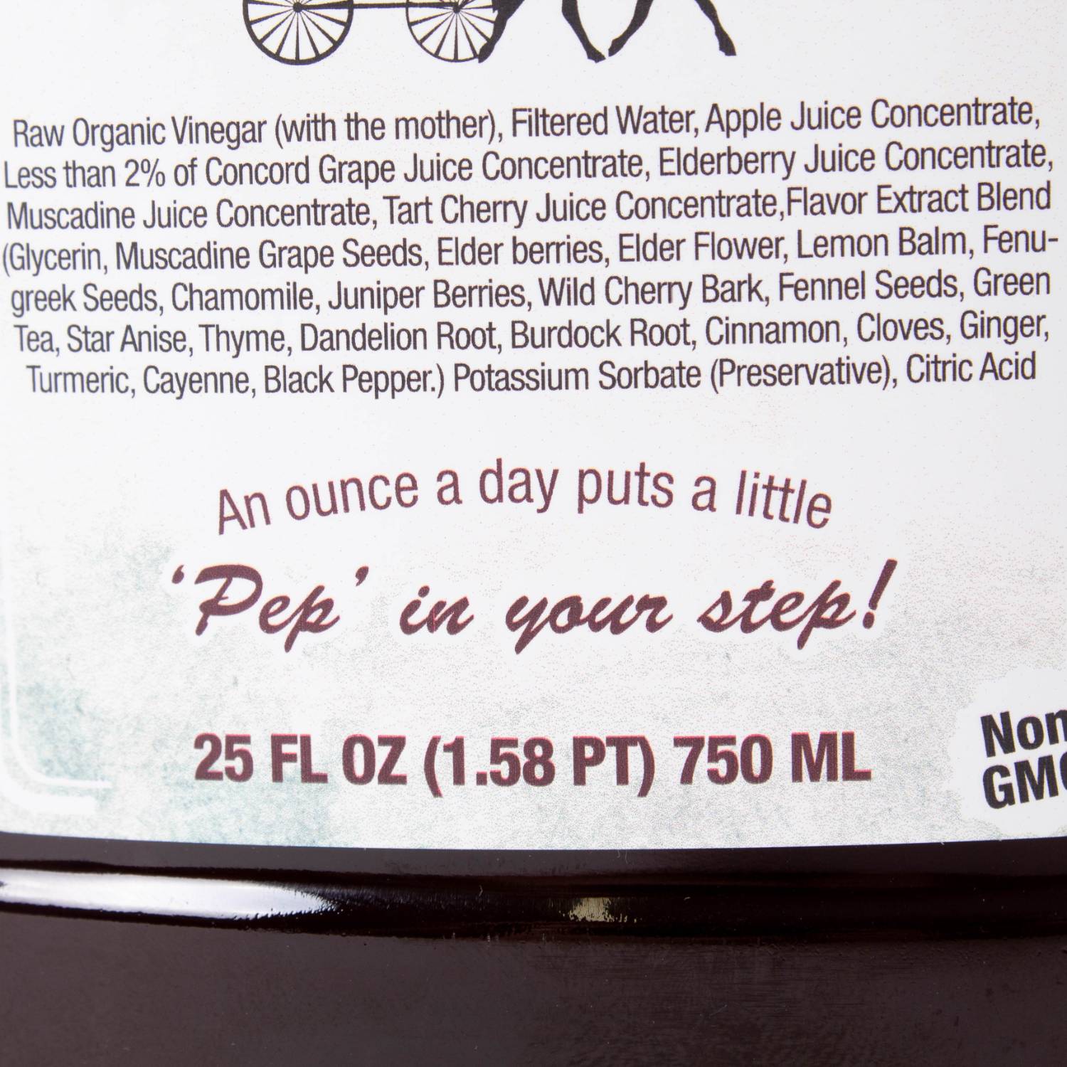 Close-up of herbal tonic label listing organic juice concentrates, herbs, and daily use recommendation on amber bottle