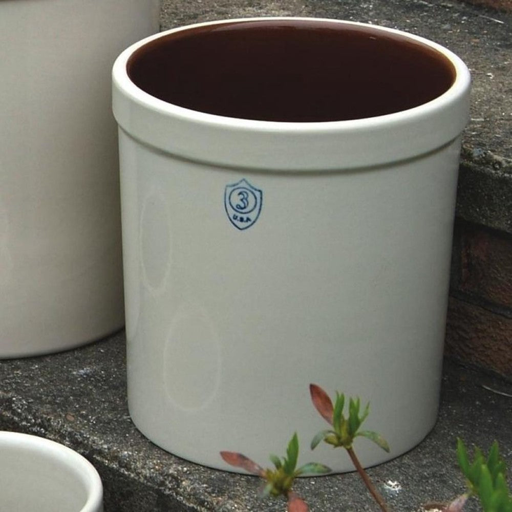 Classic white stoneware crock with dark brown glazed interior and blue three-gallon capacity shield mark