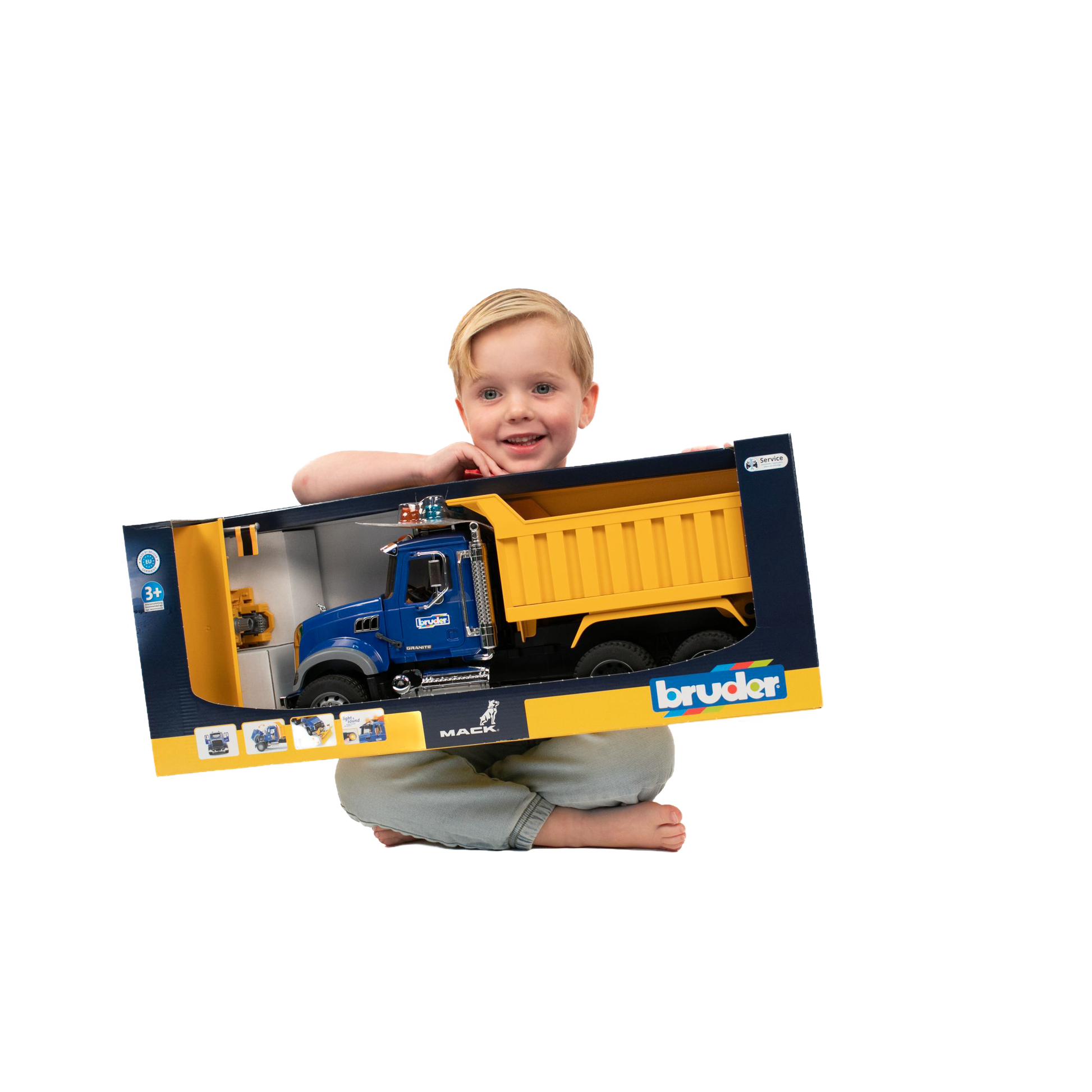 Child holding large blue and yellow Bruder Toys 1:16 scale Mack Granite dump truck box from Vehicles & Remote Controlled Toys collection