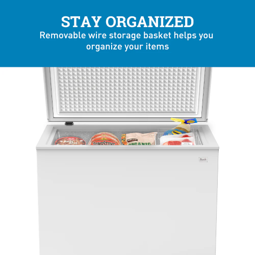 White garage-ready chest freezer with open lid and removable wire storage basket holding frozen food items