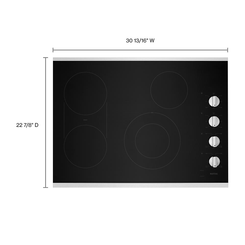 Glass electric cooktop with four heating zones and side control knobs for kitchen and cooktop appliance collections