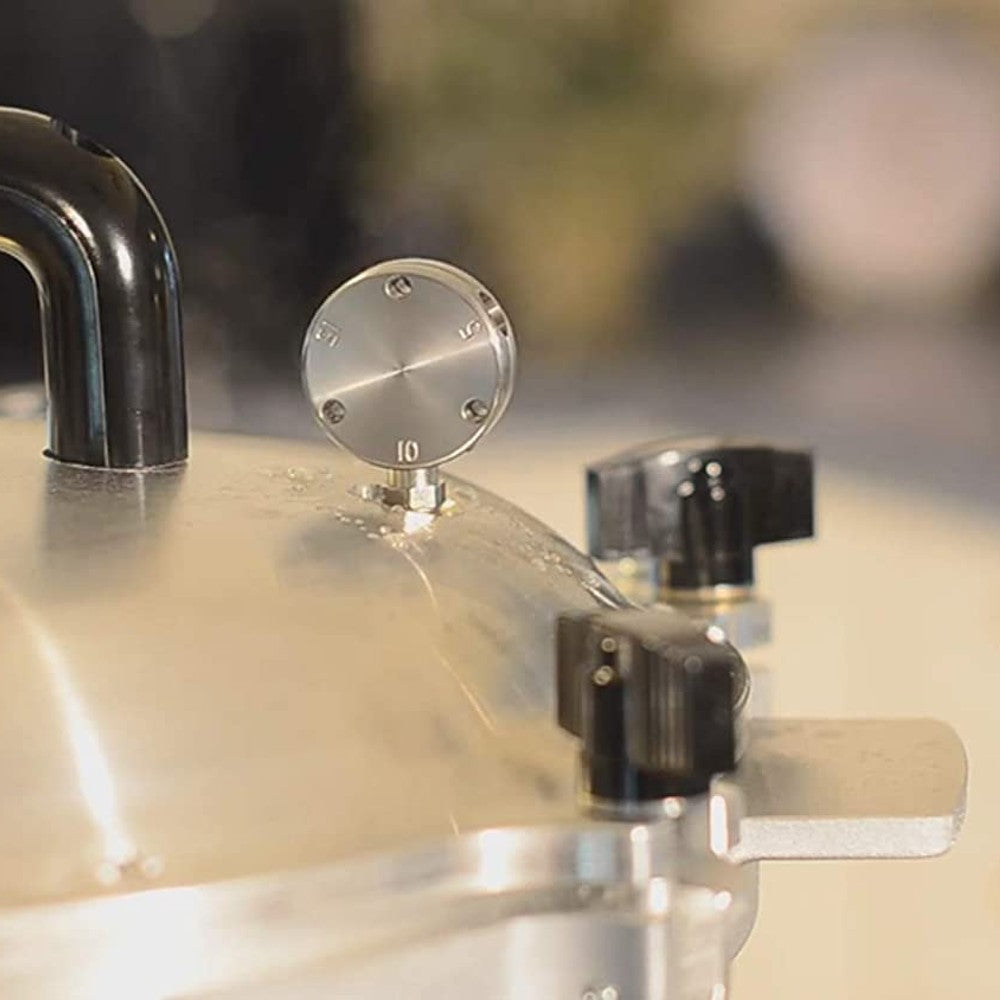 Close-up of pressure regulator dial and black control knobs on aluminum pressure canner in kitchenware collections
