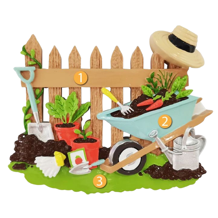Garden scene ornament with wooden fence, wheelbarrow, potted plants, shovel, watering can, and gardener’s hat for Christmas decor under $50