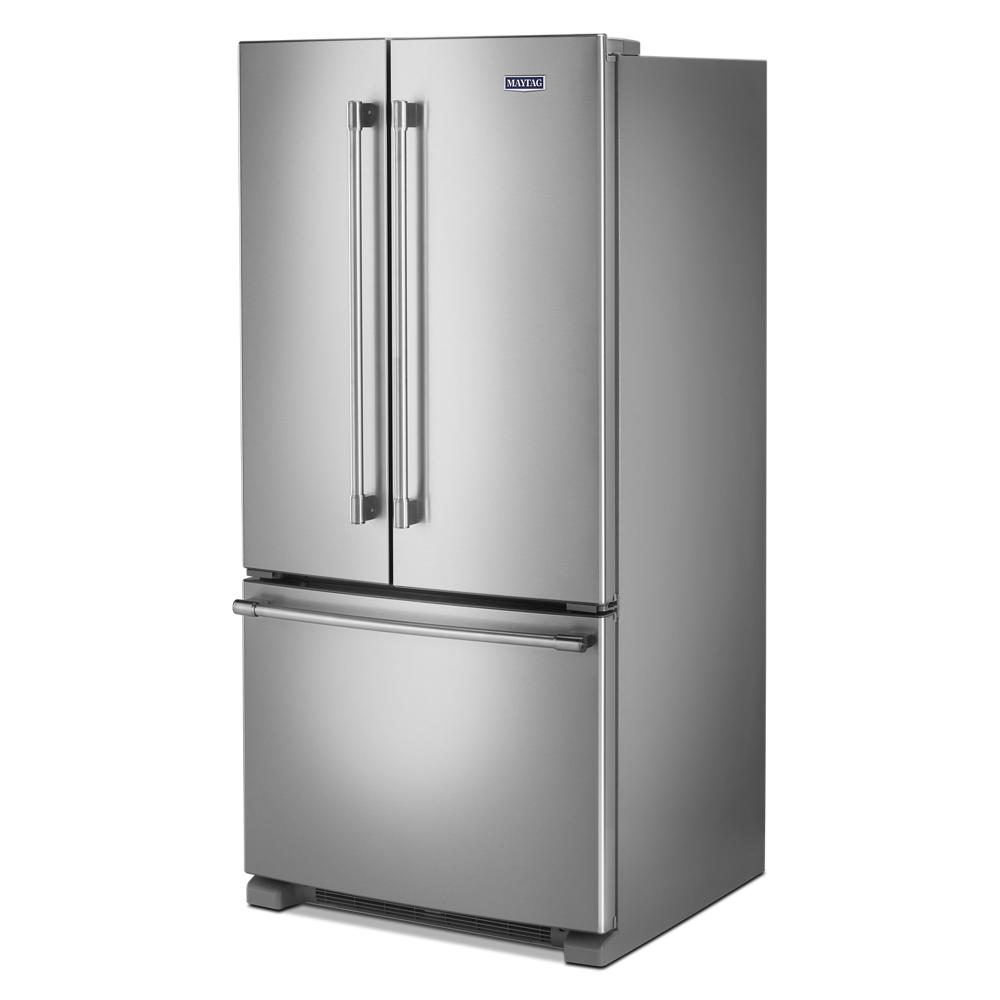 Stainless steel french door refrigerator with bottom freezer drawer and vertical handles in kitchen appliances collection