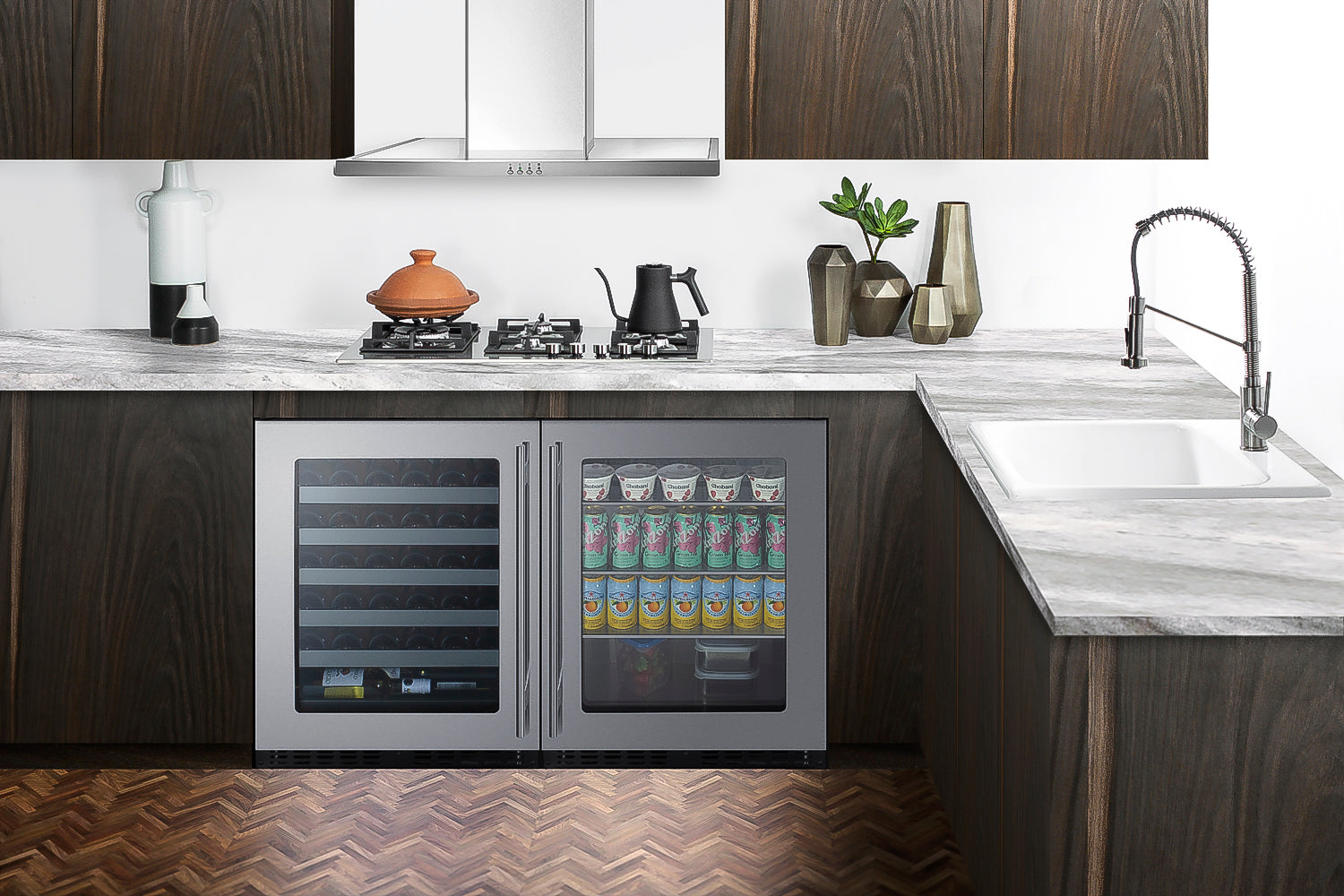 Under-counter beverage center with dual glass doors, stainless steel frame, stocked with drinks, in modern kitchen setting