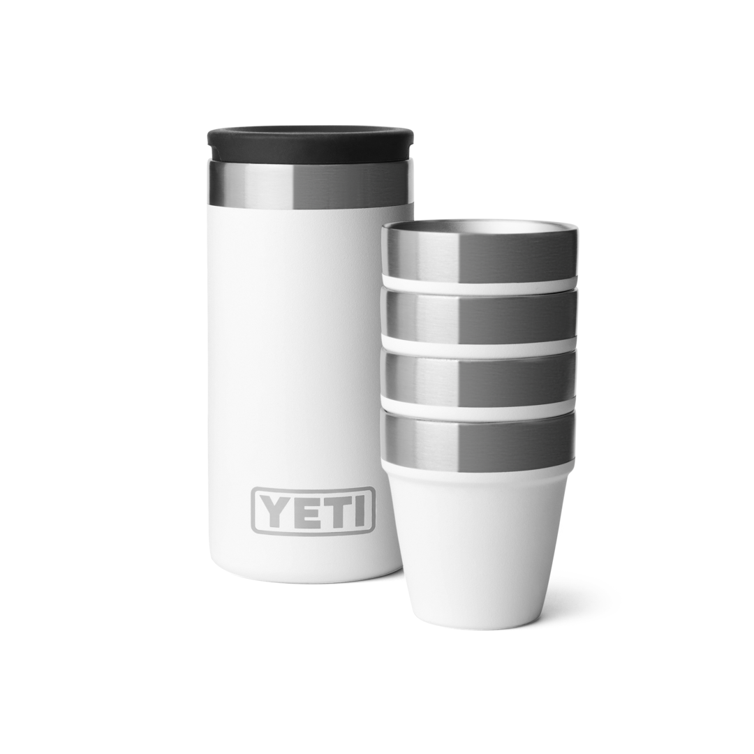 White insulated carrying case next to four stacked stainless steel and white shot glasses for durable drinkware use