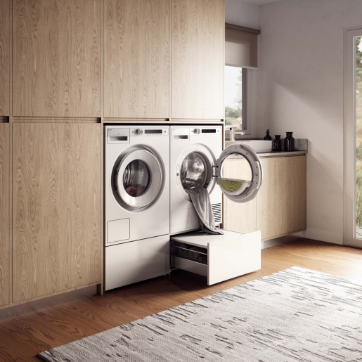 Modern laundry room with front-load washer and dryer, featuring a white pull-out drawer for storing laundry essentials.