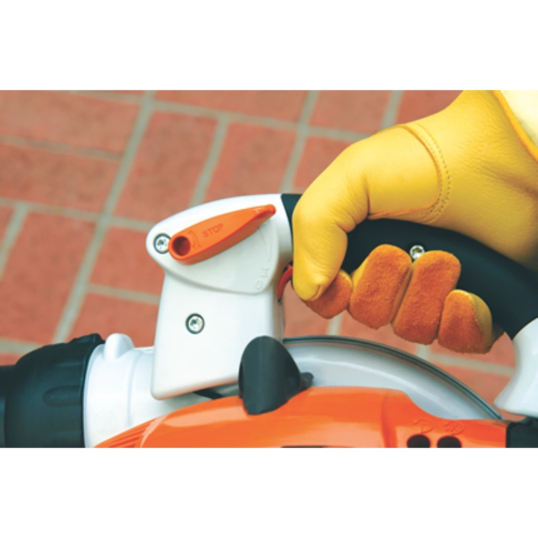 Hand gripping gas-powered blower handle with ergonomic orange and white housing for outdoor home improvement tasks