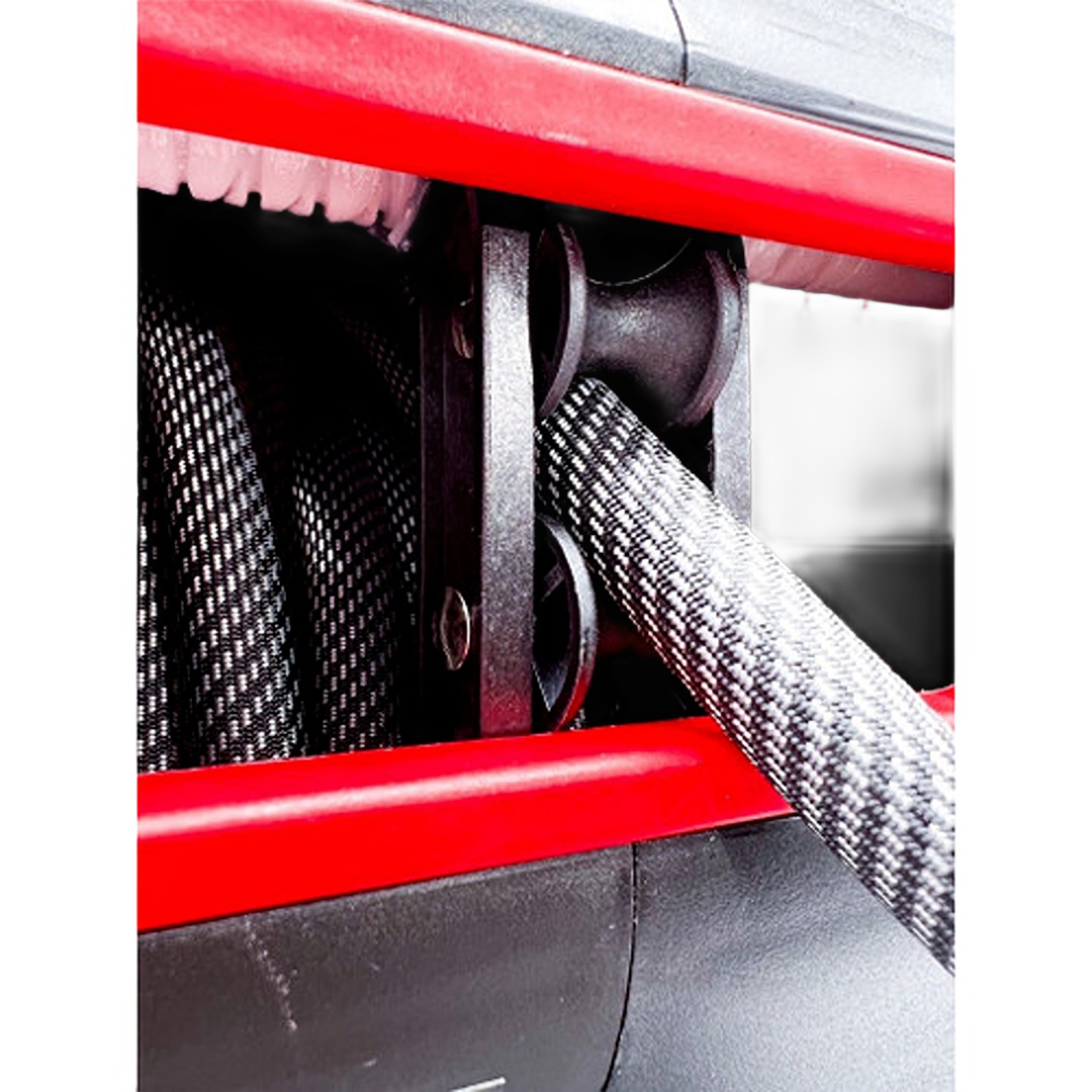 Heavy-duty self retracting air hose reel with textured black hose and red metal frame for air tools and home improvement collections