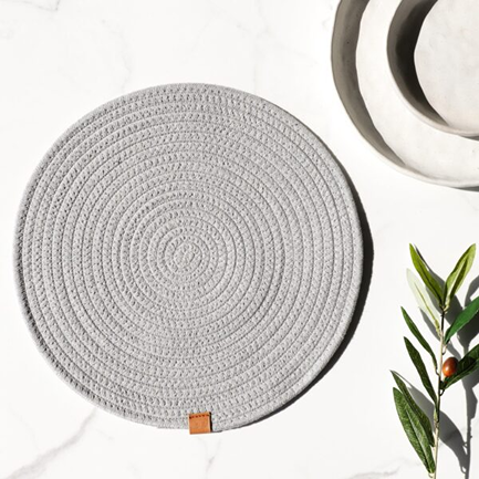 Round grey fabric placemat with woven texture, ideal for table decor and kitchenware under $50 collections