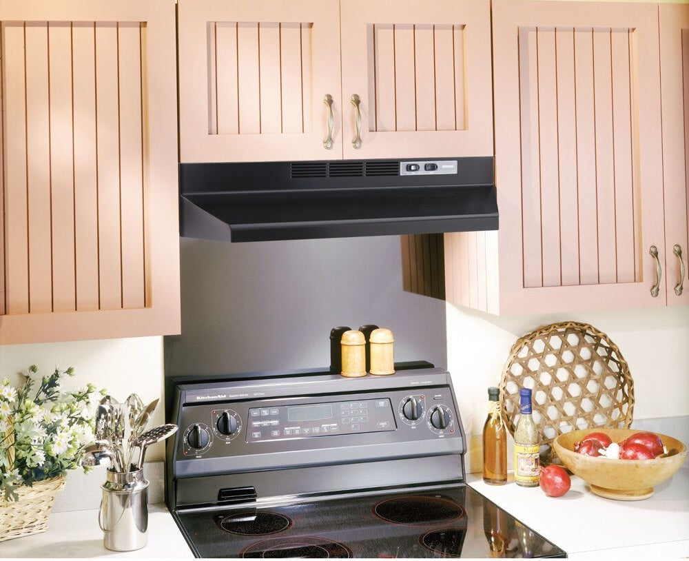 Black under-cabinet range hood with 2-speed rocker controls installed above electric stove in kitchen appliances collections