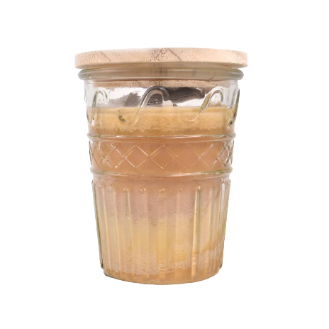 Glass jar candle with wooden lid and toasted walnut pralines scent for home ambiance and decor use
