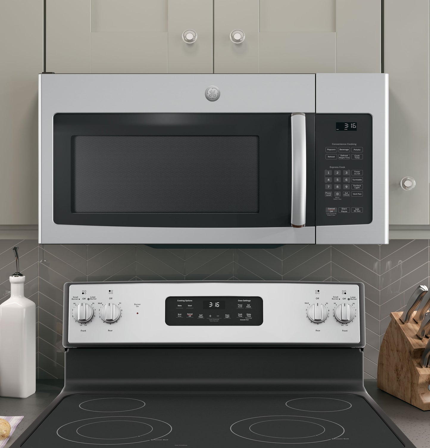 Stainless steel over-the-range microwave with digital controls installed above electric stove in a modern kitchen setting