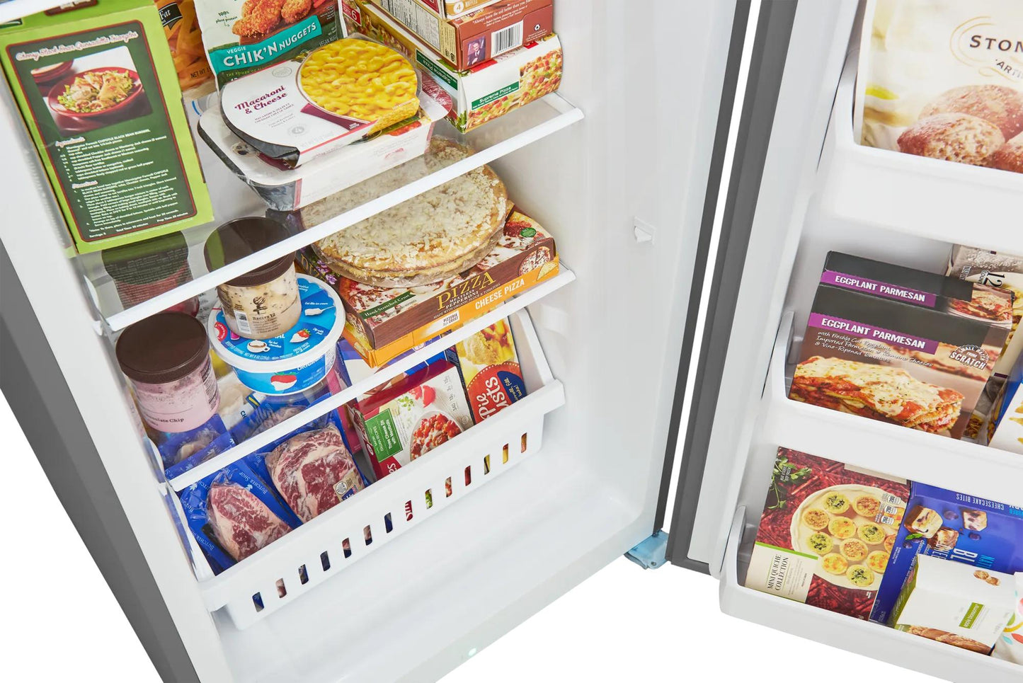 Interior view of an open freezer showing organized frozen meals, ice cream, and packaged foods, suitable for Freezers & Ice Makers, Kitchen & Kitchenware, and Appliances collections.